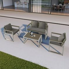 an outdoor living area with furniture and grass