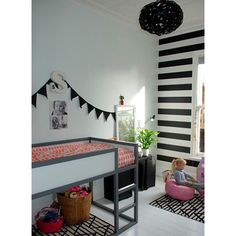 a child's bedroom with black and white striped walls