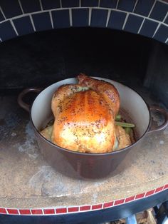 a chicken roasting in an oven with broccoli