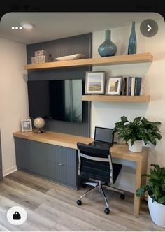 a desk with a laptop computer on top of it next to a shelf filled with books and vases