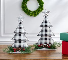 two wooden christmas trees sitting on top of a table