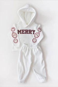 Cute holiday-themed baby outfit with a white hoodie, 'MERRY' text, and smiling faces on the sleeves, matched with soft white pants. Festive Activities, Winter Baby Clothes, Neutral Baby Clothes, Hoodie Pants, Holiday Essentials, Smiley Faces, Comfy Pants, Gender Neutral Baby Clothes