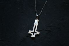 Upside down cross with a hollowed out design. Made in very shiny stainless steel. Comes with chain! Ships worldwide from Sweden! © 2020 Torvenius Illustration ABModel is Christina Zelmerlöw feathersandflesh_@instagram Handmade Stainless Steel Cross Pendant Jewelry, Handmade Stainless Steel Cross Pendant Necklace, Handmade Stainless Steel Cross Pendant, Handmade Stainless Steel Cross Necklace, Handmade Stainless Steel Cross Jewelry, Upside Down Cross, Pin Button Badges, Coin Set, Hollow Design