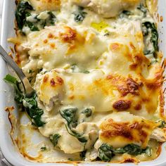 a casserole dish with spinach, cheese and chicken in it is ready to be eaten