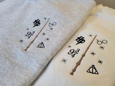 two harry potter t - shirts laying next to each other