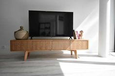 a television sitting on top of a wooden entertainment center