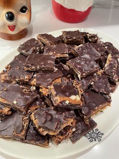 a white plate topped with pieces of chocolate