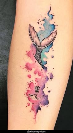 a watercolor tattoo with a mermaid tail