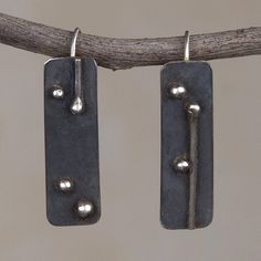 A unique design from Leslie Granthon of Peru this pair of drop earrings makes a bold accessory. Each rectangular earring is crafted from sterling silver and given a dark oxidized finish. Cheap Rustic Nickel-free Earrings, Cheap Symbolic Metal Earrings, Luxury Modern Hand Forged Earrings, Cheap Handmade Metal Earrings, Drop Earrings Silver Handmade Jewelry, Luxury Oxidized Finish Dangle Earrings, Luxury Artisan Sterling Silver Earrings, Cheap Oxidized Metal Earrings, Cheap Artistic Metal Earrings