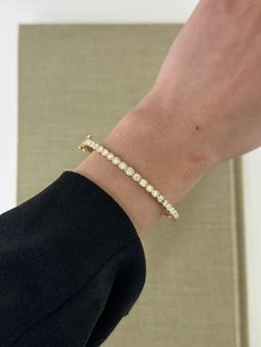 Curate a bracelet collection that reflects your distinct style with our timeless diamond bezel bangle. Adorned with round diamonds elegantly set in squared bezels, it exudes classic charm. Available in 14k Yellow Gold, White Gold or Rose Gold Diamond Color: F/G / Diamond Clarity: VS1 Total Carat Weight: 1.15 ct Closure: Snap-Double Lock Clasp 4mm x 2mm 7 inch length Made to order. Lead time is 4-6 weeks. Benefits of Solid 14k Gold Jewelry Most loved for its durability and longevity Can be worn d Luxury Round Bangle With Bezel Setting, Elegant Bezel-set Bangle Jewelry, Elegant Tennis Bracelet In Diamond White With Bezel Setting, Elegant Diamond White Tennis Bracelet With Bezel Setting, Elegant Gold Bracelet With Diamond Bezel Setting, Elegant Diamond Gold Bracelet With Bezel Setting, Luxury Diamond Bracelet With Bezel Setting For Everyday, Luxury Diamond White Tennis Bracelet With Bezel Setting, Luxury Tennis Bracelet In Diamond White With Bezel Setting