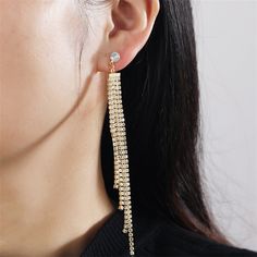 Elegantly accentuate your appearance with this pair of drop earrings featuring 18k gold-plated tassel extensions covered in cubic zirconia details. 0.35" W x 4.3" L 18k gold-plated copper / cubic zirconia Gold Tassel Dangle Earrings With Rhinestones, Gold Rhinestone Tassel Dangle Earrings, Gold Crystal Tassel Earrings For Evening, Dangle Tassel Earrings With Rhinestone Fringe, Gold Crystal Earrings With Rhinestone Fringe, Elegant Gold Earrings With Rhinestone Fringe, Elegant Rhinestone Tassel Drop Earrings, Glamorous Gold Tassel Earrings With Rhinestones, Gold Tassel Earrings With Rhinestone Fringe