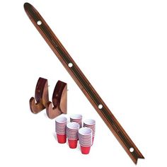 a set of four red and white cups next to a pair of wooden handled knives