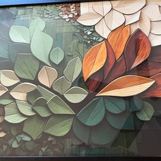 a painting on the side of a building with leaves painted on it's sides