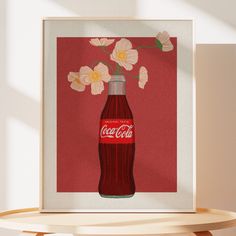 a red coca - cola bottle with flowers in it