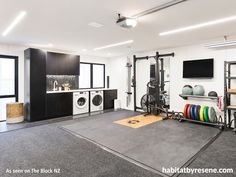 a home gym with black cabinets and white walls