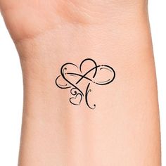 a woman's wrist with a tattoo design on the left side of her arm