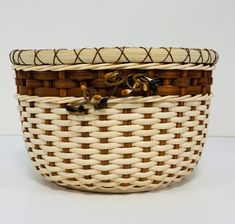 a woven basket with gold and black accents