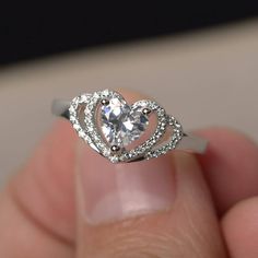 This is a gorgeous handmade creation. Its beauty is its simplicity & Elegance. The 6*6 mm heart cut faceted Cubic Zirconia is crafted in solid sterling silver and with rhodium plated. All item is sent in a beautiful gift box If you have any idea of design your ring,pls contact me directly. You can realize more lovely stuff clicking the link https://www.etsy.com/shop/knightjewelry?refshopsection_shophome_leftnav Please leave the correct address and you phone number for delivering successfully Heart Cut Ring, Heart Shaped Diamond Ring, Heart Shaped Engagement Rings, Cute Promise Rings, Rings Heart, Heart Wedding Rings, Rings Inspiration, Vintage Halo, Wedding Engagement Rings