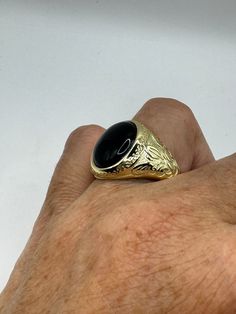 This is a Persian-styled vintage onyx mens ring set in 925 sterling silver accented with 14k gold and a genuine black onyx. This is a gorgeous ring, intricate detail work on the silver set with a beautiful onyx. We have in a sizes 9, 10 11 or 12 this can be sized to your specification, please message us to discuss sizing your ring there is a $20 fee. or engraving options. All of our jewelry is hand polished and shipped to you in a stylish gift box.  We are happy to gift wrap for you.  It is impo Timeless Black Signet Ring With Gemstone, Classic Onyx Signet Ring With Black Enamel, Classic Gold Onyx Rings, Classic Black 14k Stamped Jewelry, Classic Black Signet Ring For Formal Occasions, Classic Black Onyx Rings, Classic Black 14k Gold Ring, Black 14k Gold Engraved Jewelry, Engraved 14k Black Gold Jewelry