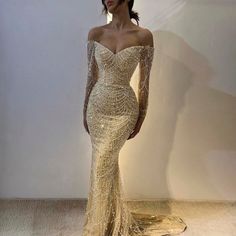 Introducing our Elegant Off-the-Shoulder Mermaid Luxury Dubai Evening Dress, a timeless and sophisticated choice for women attending weddings, parties, or formal events. This exquisite gown exudes opulence and grace, perfect for making a statement on any special occasion. Crafted with meticulous attention to detail, this dress features an off-the-shoulder neckline that elegantly frames the décolletage, while the mermaid silhouette accentuates the curves for a flattering fit. The long sleeves add Long Sleeve Prom Dress Mermaid, Formal Dresses Mermaid, Dubai Evening, Floor Length Prom Dresses, Mermaid Sequin, Long Sleeve Prom, Long Sleeve Dress Formal, Long Sleeve Evening Dresses, فستان سهرة