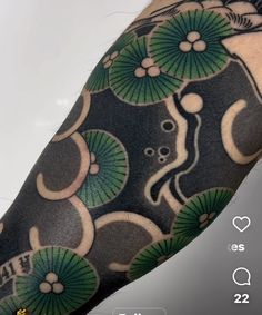 a person with a black and green tattoo on their arm