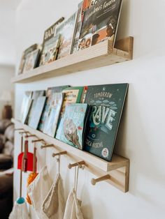 there are many books on the wall and hanging from the hooks in front of them