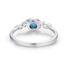 A celestial masterpiece that will leave you spellbound. Our Planet Ring features a london blue topaz center stone that captures the enchanting allure of Saturn, crafted with meticulous detail. Adding to the celestial allure, delicate accents of aquamarine and white gems gracefully orbit around the center stone, reminiscent of twinkling stars in the night sky. Embrace the magic of the universe and let your style soar to new heights. Let your own unique light shine brightly. ✦ Available in both 14 Blue Celestial Moonstone Ring, Celestial Blue Topaz Ring For Gift, Blue Celestial Ring With Center Stone, Celestial Blue Topaz Ring Gift, Blue Topaz Crystal Ring With Gemstone Accents, Celestial Blue Round Moonstone Ring, Celestial Blue Rings With Accent Stones, Blue Celestial Rings With Accent Stones, Celestial Blue Moonstone Ring