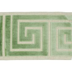 a rug with green and white squares on the bottom, in front of a white background