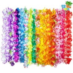 a bunch of colorful streamers hanging from the side of a white wall in different colors