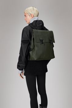 MSN Bag reinterprets the classic school backpack for city-ready wardrobes. Characterized by a minimalistic silhouette and flap with carabiner closure. This bag features an internal laptop pocket, a spacious main compartment and finished off with snap compressions at opening and sides. The laptop pocket fits a 13" laptop with sleeve, making the MSN Bag a perfect computer-ready staple for everyday commutes. MSN Bag is cut from Rains' signature PU fabric, engineered for carrying strength, durabilit