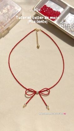 a red string bracelet with beads and a bead on the end is sitting on a table