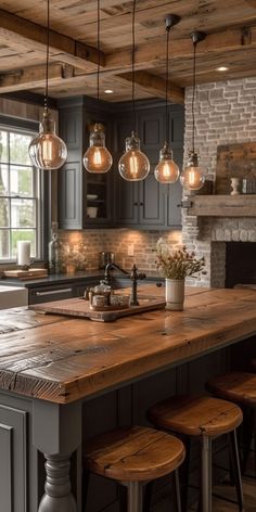 a kitchen island with stools and lights hanging from it's ceiling in front of an oven