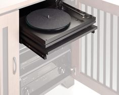 a turntable sitting on top of a cabinet