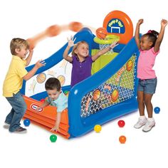 three children playing in an inflatable ball pit