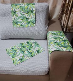 a chair with two matching pillows on top of it and another pillow in the back