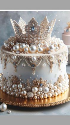 a three tiered cake with pearls on top