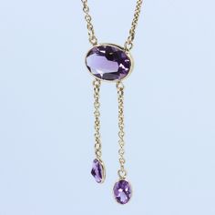 "Vintage Minimalist Lavalier Necklace in 14k Gold with Bezel Set, Oval Cut, Amethysts. This necklace bears a makers hallmark with \"rings and the letter A\", there is also a 14k Purity mark, no origin mark. Necklace measures 15.75\" Total Drop of Lavalier Pendant 1.75\" 1X - 13.6x9.8x5.85 mm Large Amethyst Oval Gem 2X - 7x4.5x3.75 mm Small Amethyst Oval Gems Total weight of necklace 0.179 Oz (78.1 g) This item is vintage. It has been cherished, worn, and preserved by possibly many over the decad Delicate Oval Pendant Necklace For Formal Occasions, Delicate Oval Necklace For Formal Occasions, Dainty Briolette Necklace For Formal Occasions, Dainty 14k Gold Drop Necklace For Formal Occasions, Formal 14k Gold Drop Necklace With Adjustable Chain, Elegant Oval Pendant Gemstone Drop Necklace, Delicate Hallmarked Necklaces For Formal Occasions, Formal Drop Necklace With Bezel Setting, 14k Gold Pendant Drop Necklace For Formal Occasions