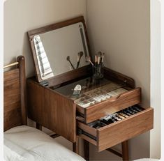 a wooden vanity with mirror and drawers in a bedroom