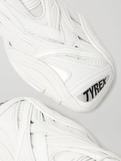 Balenciaga's 'Tyrex' sneakers are a cool adaptation of indoor football cleats. Made in Italy from a combination of rubber, mesh and faux leather, this white pair has supportive overlays, moulded soles and square toes featuring the style name. Wear them with: Balenciaga T-shirt, Balenciaga Trousers, Balenciaga Bag, Balenciaga Bracelet. White Leather Running Shoes With Vibram Sole, Leather Sneakers With Reflective Details For Light Sports, Leather Running Sneakers With Reflective Details, Sporty Leather Sneakers With Reflective Details, Leather Sneakers With Reflective Details For Sports, White Leather Sneakers With Reflective Details, White Functional Running Shoes With Studded Outsoles, Sporty Leather Running Shoes With Reflective Details, White Leather Training Sneakers