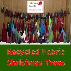 a table topped with lots of christmas trees covered in red, green and blue fabric