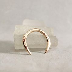 a gold ring sitting on top of a rock