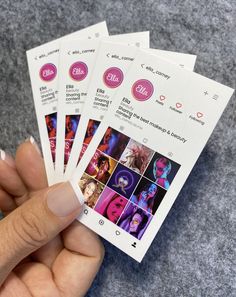 a person holding four tickets with photos on them in their hand and the number one