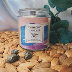 a candle sitting on top of a table next to some rocks