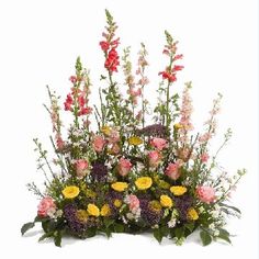 an arrangement of flowers arranged in a basket