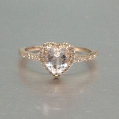 an engagement ring with a heart shaped diamond in the center