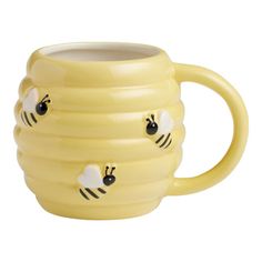 a yellow mug with two bees on it's sides and one has its eyes closed