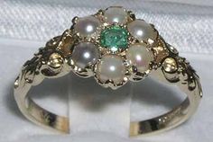 "*This ring is made from 375 9K Yellow Gold with Natural Emerald & Pearls. One center 3mm (0.12\" inches) colorful green Emerald & six Freshwater Pearl all hand set in this charming Solid 9K Yellow Gold Antique style Daisy setting, so full of character. The One central Emerald surrounded by six Elegant Genuine Pearls.  *Height 4mm, Width 10mm, Length 10mm PLEASE MAKE SURE YOU STATE THE FINGER SIZE YOU REQUIRE WITH YOUR PAYMENT AND YOUR TELEPHONE NUMBER FOR DELIVERY. A really impressive ring and unusual in design.  Completely made from Solid English 9K Yellow Gold Hallmarked by the London Assay Office which confirms the rings authenticity. The Hallmark includes the 375 marking for 9K Gold.  This is a delightful piece to wear, comfortable and easy to wear everyday, large enough to be noticed Green Pearl Round Ring For Anniversary, Green Pearl Ring For Anniversary, Formal Green Flower-shaped Ring, Green Flower-shaped Emerald Ring For Anniversary, Victorian Multi-stone Green Jewelry, Green Flower-shaped Ring For May Birthstone, Victorian Green Multi-stone Jewelry, Green Flower Rings For May Birthstone, Green Victorian Multi-stone Jewelry