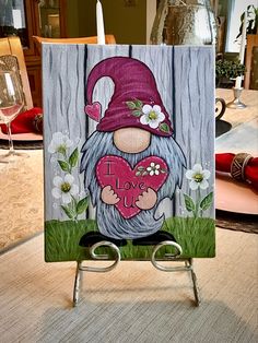 a card with an image of a gnome holding a heart in it's hands