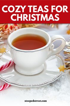 a cup of tea sitting on top of a saucer next to candy canes