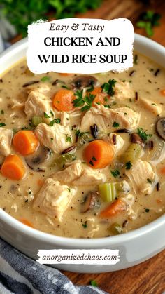 a white bowl filled with chicken and wild rice soup on top of a wooden table